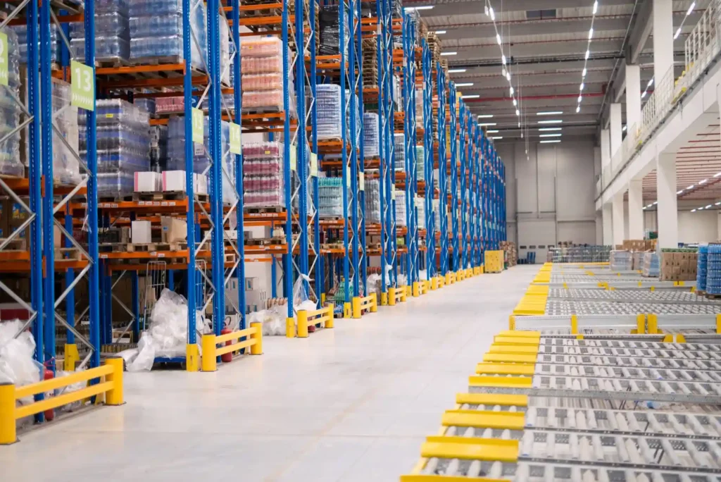 Warehouse shelves with organized blue racks, safety barriers, and logistics systems