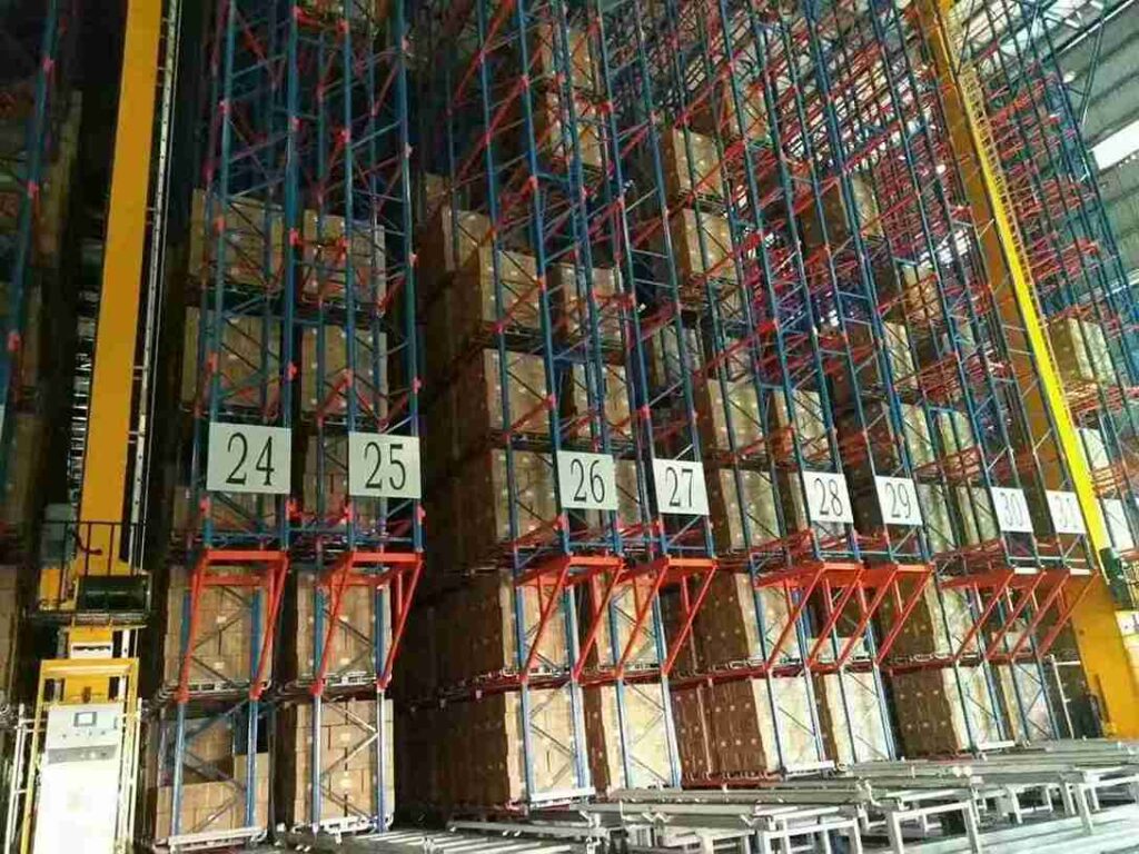 Seamless ASRS and AGV handoff interface in an industrial racking warehouse layout