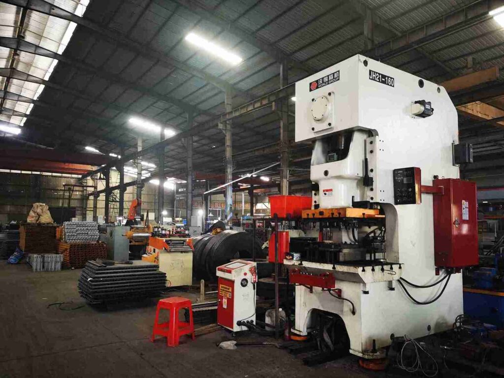 Warehouse safety infrastructure with column guards and placards supporting a proactive beam racking inspection checklist.