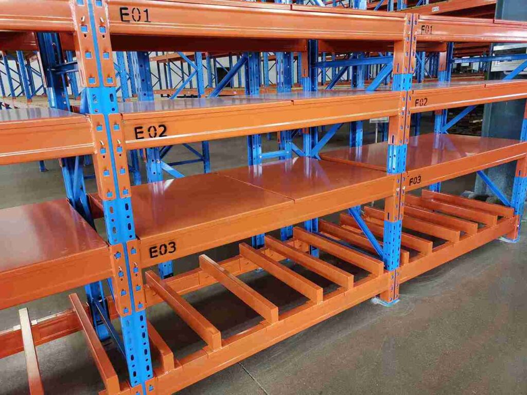 Worker easily adjusting shelf height on industrial Adjustable Warehouse Shelving with tool-less design