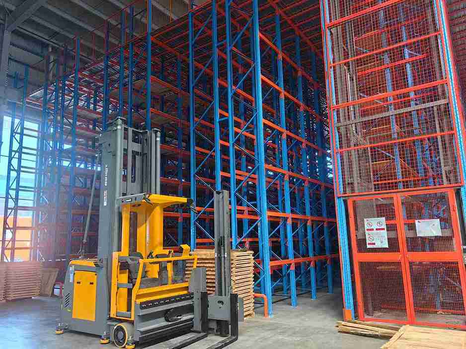 AGV operating safely next to pallet rack safety barriers in an automated warehouse.