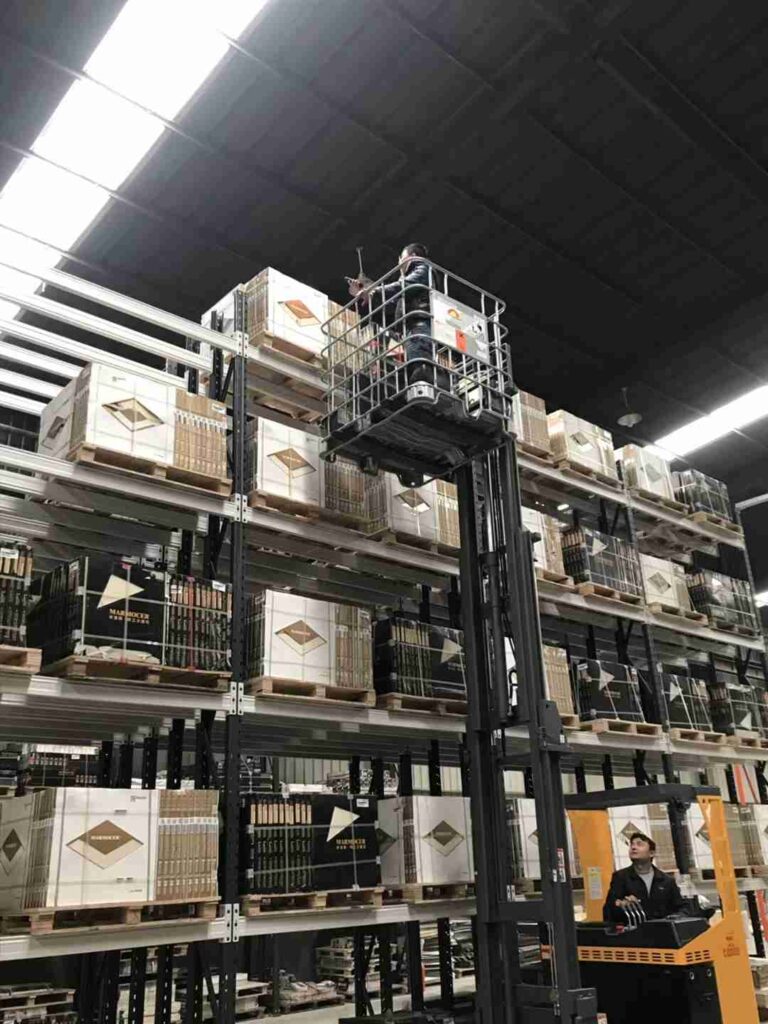 AGV operating seamlessly alongside automation-ready pallet rack post types.