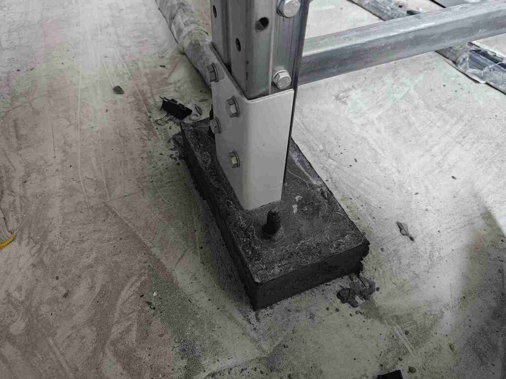 Engineer conducting concrete strength testing prior to installing pallet racking anchors.