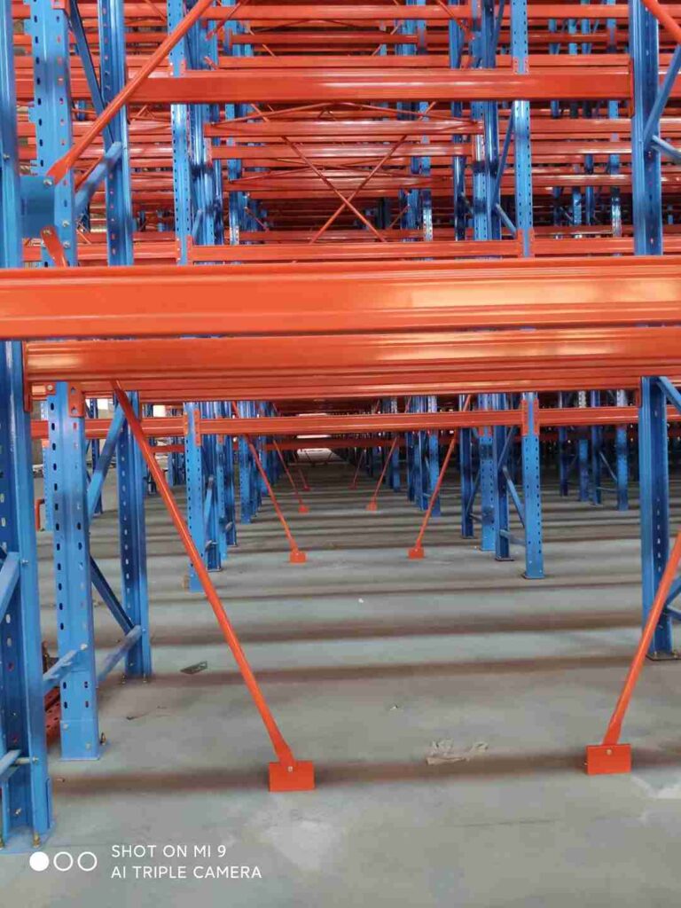 Engineered design of high-density narrow aisle racking in distribution centers with guide rails and reinforced structure.