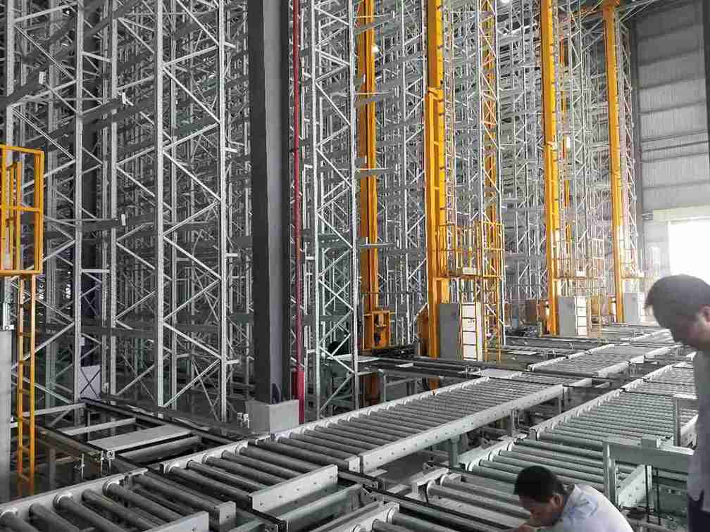 Engineers performing precision alignment check during installation of a narrow aisle racking for pharma storage system.