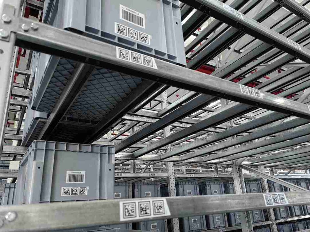 Industrial pallet rack label close-up showing durable materials, scannable barcode, and clear text for warehouse identification.