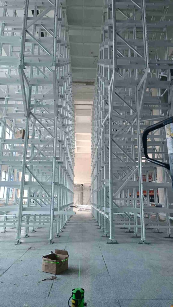 Professional beam racking layout planning dimensional analysis with laser measurement equipment in warehouse setting