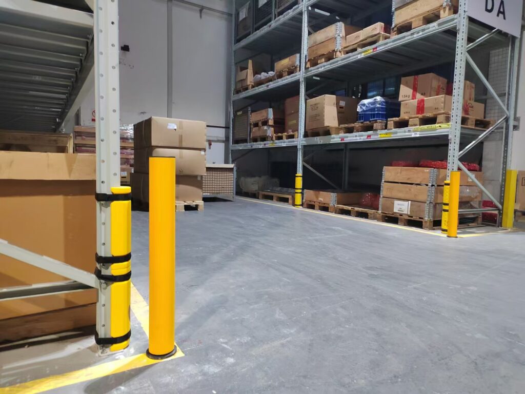 Yellow UHMW-PE column protectors for beam racking damage prevention in high-traffic warehouse