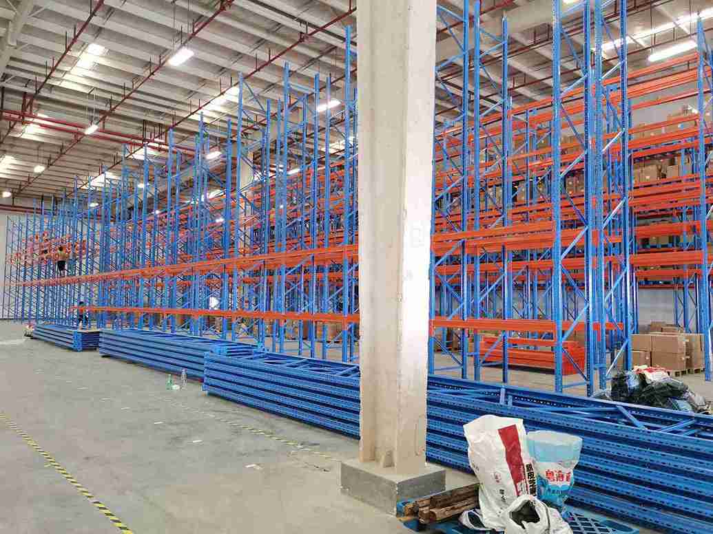 pallet racking installation technician with alignment tools