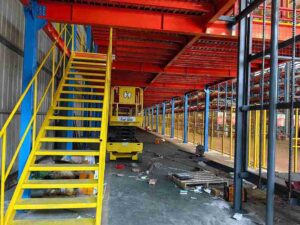 Modular platforms and stairs installation for warehouse automation