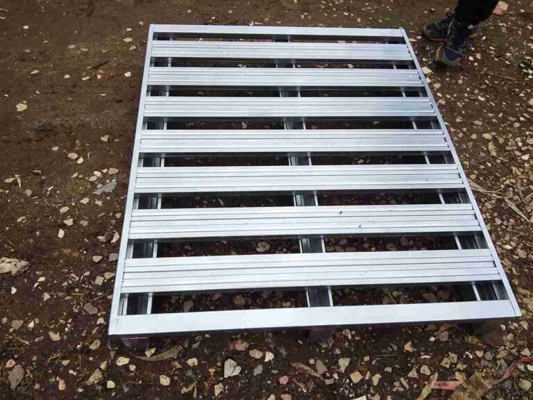 Heavy-duty iron pallet maintaining load stability on an AGV during transport
