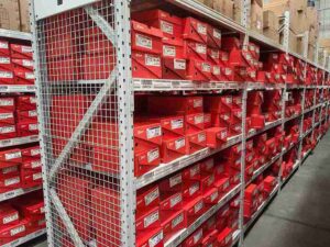 High-density warehouse storage utilizing tall boltless shelving systems to maximize space