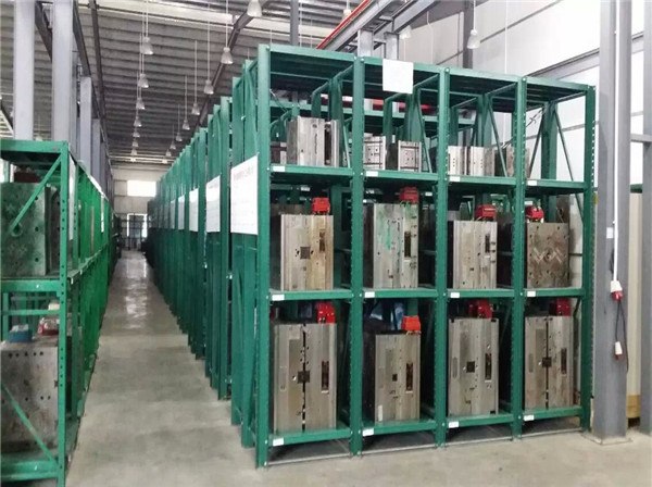 organized warehouse with heavy duty drawer type mold rack installation