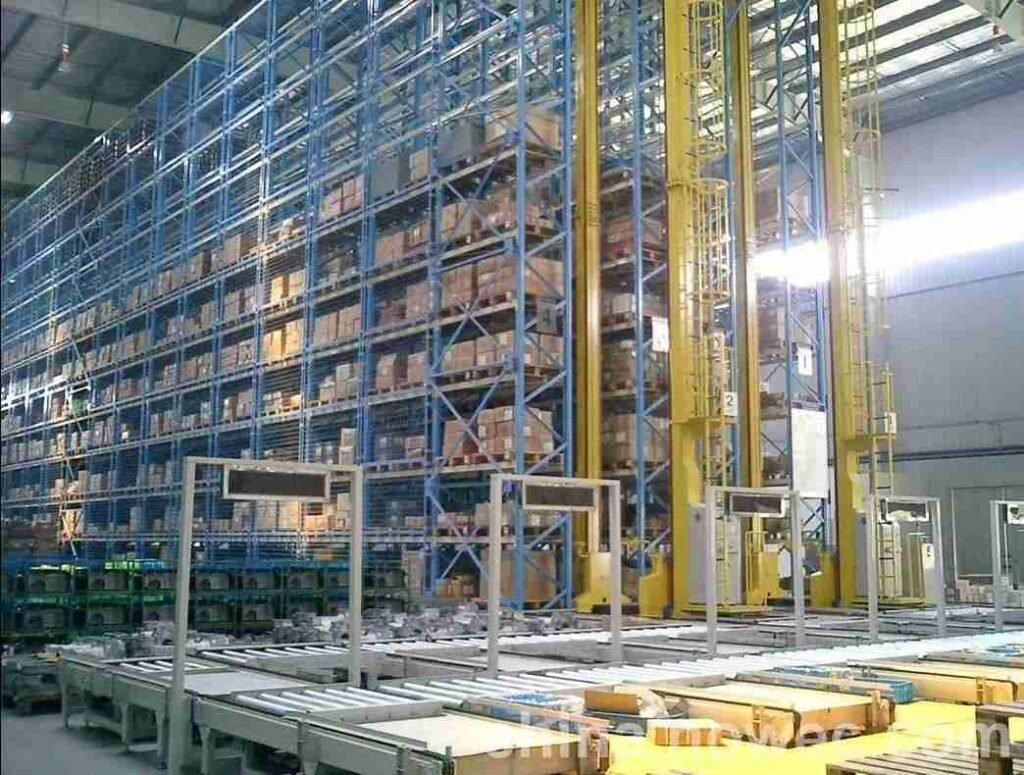 Modern High Bay Warehouse With Stacker Crane Operating In Narrow Aisle